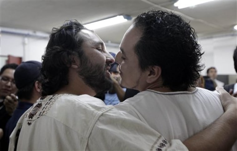 Carlos Alberto Ramos, right, and Javier Gutierrez kiss after beginning the legal process toward marriage in a city government building in Mexico City, Thursday.